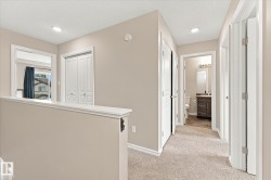 Plush carpeted hallway with recessed lighting - 