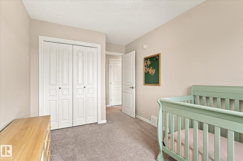 Neutral-toned walls, gray carpet, paneled closet doors, and a white interior door - 21935 91 Avenue Nw, Edmonton, AB 