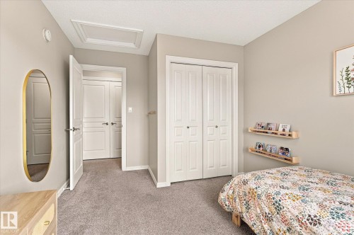 Neutral-toned walls complement the gray carpeting - 21935 91 Avenue Nw, Edmonton, AB 
