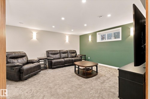 Recessed lighting, wall-mounted sconces, light-toned carpeting, and a window with blinds - 21935 91 Avenue Nw, Edmonton, AB 