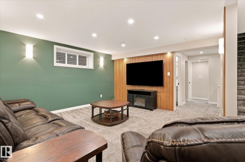 Recessed lighting, wall sconces, wood panel accent wall, window with blinds, and carpeted flooring - 21935 91 Avenue Nw, Edmonton, AB 