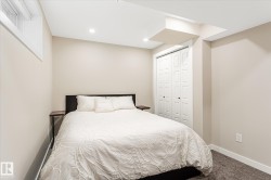 Recessed lighting, neutral wall paint, bi-fold closet doors, carpeting, and a window - 