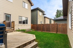 Expansive wooden deck with steps, leading to a vibrant green lawn - 