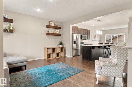 Hardwood-finish flooring, recessed lighting, and built-in floating shelves - 21935 91 Avenue Nw, Edmonton, AB 