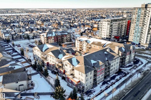 Low-rise apartment building featuring multiple stories, balconies, and a pitched roof - #202 105 Ambleside Dr Sw, Edmonton, AB 