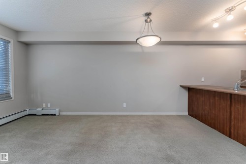 Recessed lighting, track lighting, and a drum pendant light - #202 105 Ambleside Dr Sw, Edmonton, AB 