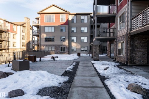 Multi-story buildings featuring balconies, stone veneer accents, and exterior siding - #403 105 Ambleside Dr Sw, Edmonton, AB 