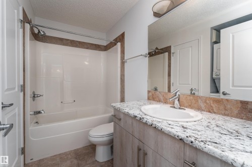 White tub and shower combination with tiled surround - #403 105 Ambleside Dr Sw, Edmonton, AB 