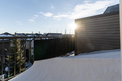 Black metal railing with an exterior privacy screen, adjacent to horizontal siding - #403 105 Ambleside Dr Sw, Edmonton, AB 
