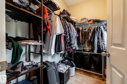 Walk-in storage space featuring neutral wall paint and carpeting - 2093 Chalmers Way Sw, Edmonton, AB 