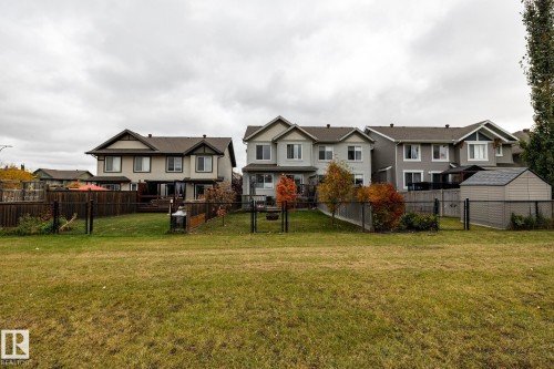 Multi-story residences featuring shingled gable roofs, siding exteriors, enclosed rear yards, and detached storage structures - 2093 Chalmers Way Sw, Edmonton, AB 