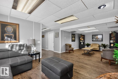 Wood-finish flooring throughout, recessed lighting, drop ceiling, and light gray walls - 5502 48 Avenue, Beaumont, AB 