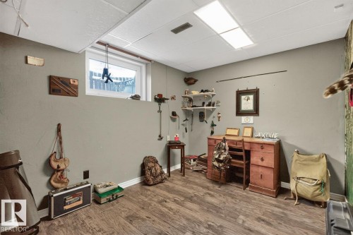 Wood-finish flooring, drop ceiling, and an egress window - 5502 48 Avenue, Beaumont, AB 