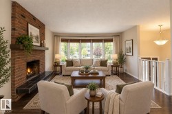 Living area featuring a brick fireplace with a wood mantle, a tiled hearth, wood-finish flooring, and a bay window - 