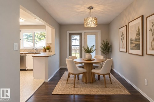 Dark wood-finish flooring with light wall tones - 17311 107 Street Nw, Edmonton, AB 