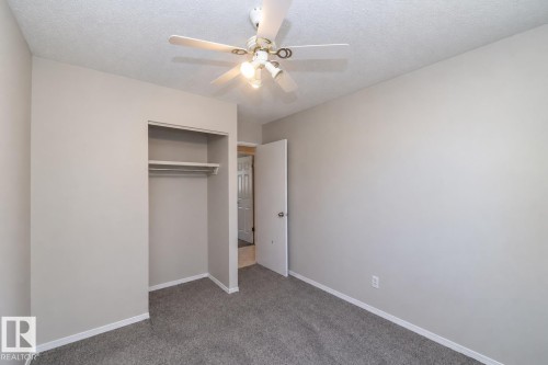 Recessed closet with shelving and hanging rod - 17311 107 Street Nw, Edmonton, AB 