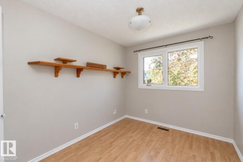 Wood-finish flooring with white trim - 17311 107 Street Nw, Edmonton, AB 