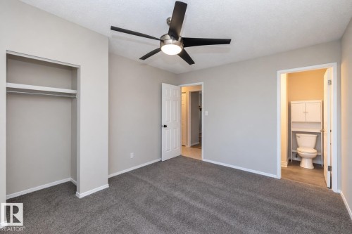Neutral paint, recessed closet, ceiling fan, grey carpeting, white trim - 17311 107 Street Nw, Edmonton, AB 
