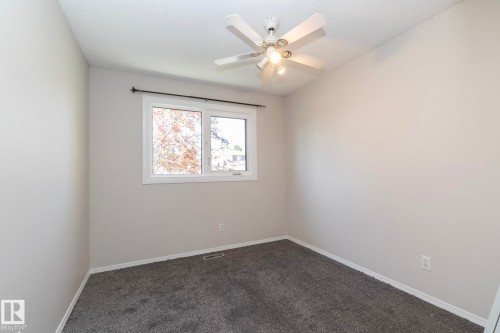 Neutral-toned walls with dark gray carpeting - 17311 107 Street Nw, Edmonton, AB 