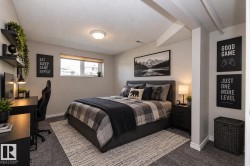 Wall-to-wall carpeting with a light-colored area rug, a window with a blind, and exposed ceiling beams - 