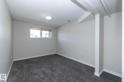 Neutral wall paint, textured ceiling, flush mount ceiling light, and a window with blinds - 