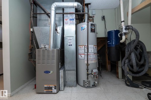 Carrier furnace and hot water tank with visible ductwork - 17311 107 Street Nw, Edmonton, AB 