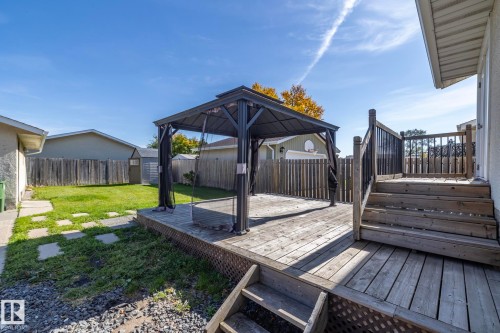 Multi-level wood deck with black metal balusters and a covered gazebo - 17311 107 Street Nw, Edmonton, AB 