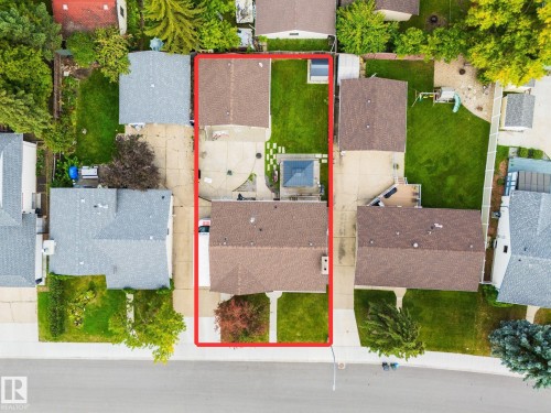 Aerial overview of the property featuring a brown shingle roof and a concrete driveway - 17311 107 Street Nw, Edmonton, AB 