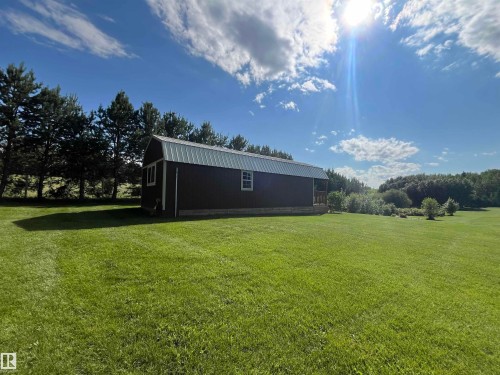 Detached outbuilding with a metal roof, board and batten siding, and white-trimmed windows - #15 2319 Twp Road 524, Rural Parkland County, AB 