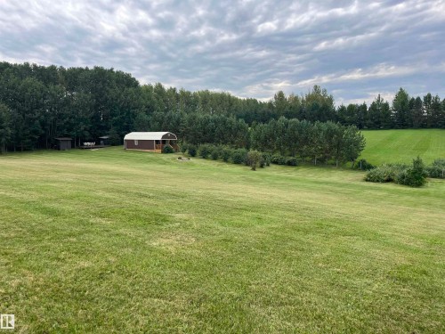 Expansive green lawn with a detached shed featuring a rounded roof and wood siding - #15 2319 Twp Road 524, Rural Parkland County, AB 