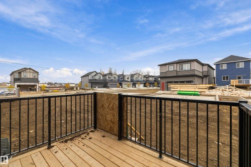 Elevated wood-decking platform with black metal railings - Edmonton, AB 