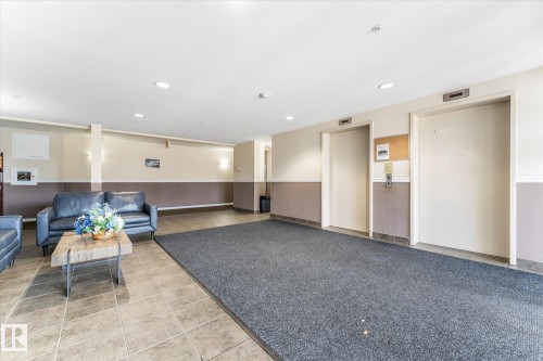 Common area featuring dual elevators, tile flooring, recessed lighting, and wall-to-wall carpeting - #109 4309 33 St, Stony Plain, AB 