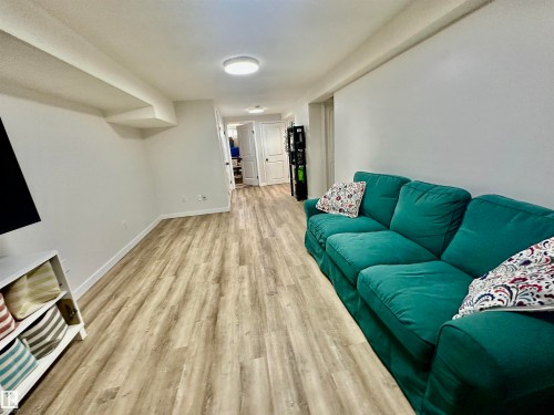 Interior space featuring wood-finish flooring, neutral walls, recessed lighting, and white interior doors - 4723 105 Street Nw, Edmonton, AB 