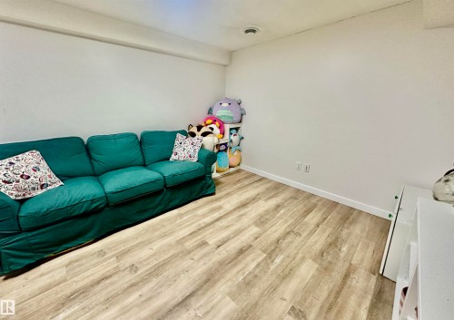 Interior space featuring wood-finish flooring and neutral wall paint - 4723 105 Street Nw, Edmonton, AB 