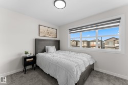 Wall-to-wall carpeting, a large window with roller shades, and a flush-mount ceiling light - 