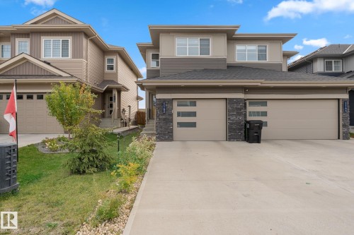 Modern exterior with multi-toned siding, stone accents, and a concrete driveway - 1142 Goldfinch Crescent Nw, Edmonton, AB 