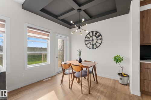 Coffered ceiling, wood-finish flooring, white walls, and a glass-paneled door - 1142 Goldfinch Crescent Nw, Edmonton, AB 