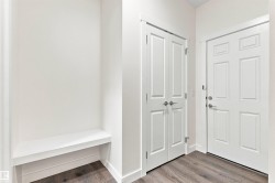 White built-in bench with a matching white paneled wall - 