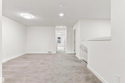 Wall-to-wall carpeting, recessed ceiling lighting, and a neutral white color palette - 