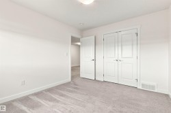 Neutral tone wall paint, light gray carpeting, white trim, and white interior doors with contemporary hardware - 