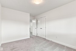 Neutral painted walls with light gray carpeting and white trim - 