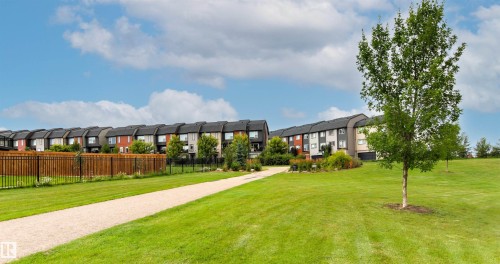 Townhome community with a gravel pathway and large grassy areas - 22019 82 Avenue Nw, Edmonton, AB 