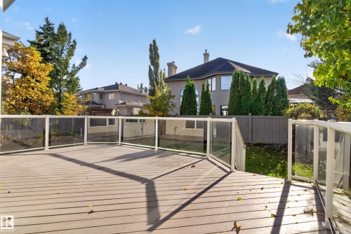Elevated deck featuring low-maintenance composite decking, glass panel railings, and privacy fencing - 876 Twin Brooks Close Nw, Edmonton, AB 