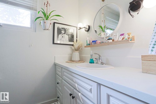 White vanity with panel-front cabinetry and black hardware - 5 Gilmore Crescent, St. Albert, AB 