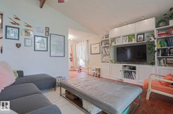 Vaulted ceiling with exposed wood beam and a ceiling fan - 