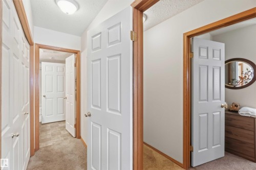 Walk in closet to partial ensuite with entry to main hallway - 497 Kananaskis Drive, Devon, AB 