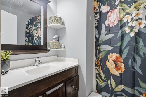 Bathroom vanity with a white countertop and integrated sink - 5340 38A Avenue Nw, Edmonton, AB 
