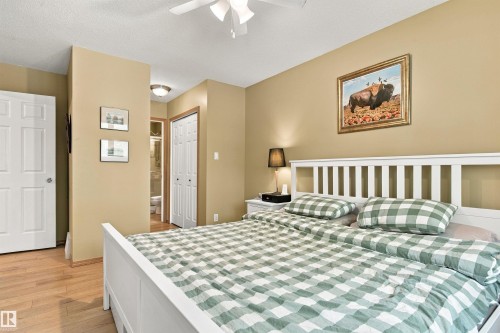 Wood-finish flooring, ceiling fan, and white paneled doors - 51064 Rge Rd 222, Rural Strathcona County, AB 
