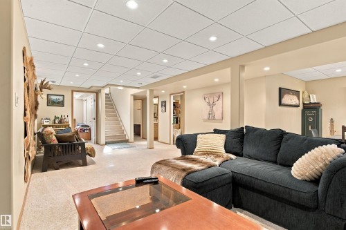 Recessed lighting illuminates a carpeted living space with neutral wall tones - 51064 Rge Rd 222, Rural Strathcona County, AB 