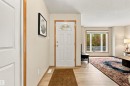 Entryway featuring wood-finish flooring, a paneled door with decorative glass, and wood trim - 51064 Rge Rd 222, Rural Strathcona County, AB 